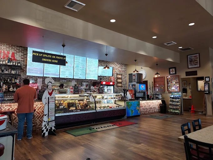 Inside Paisan’s deli: the ordering counter, menu boards, and deli cases